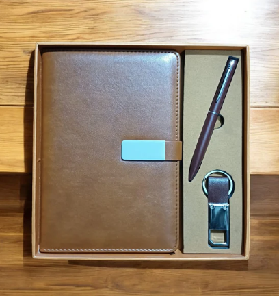 Brown leather notebook with pen and bottle opener set in a box on a wooden surface