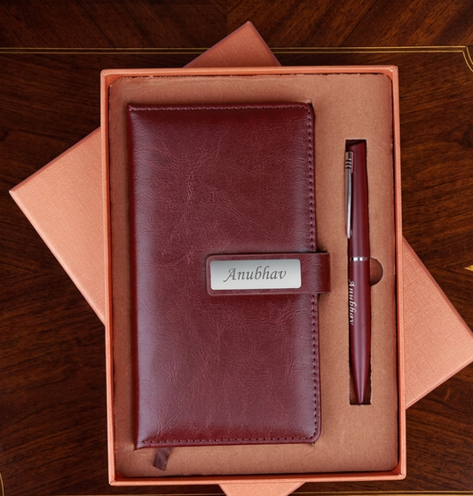 Brown leather wallet and pen set with 'Anubhav' engraving in a box on a wooden surface